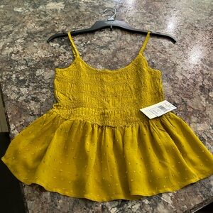Mustard tank with elastic bodice and ruffled bottom.